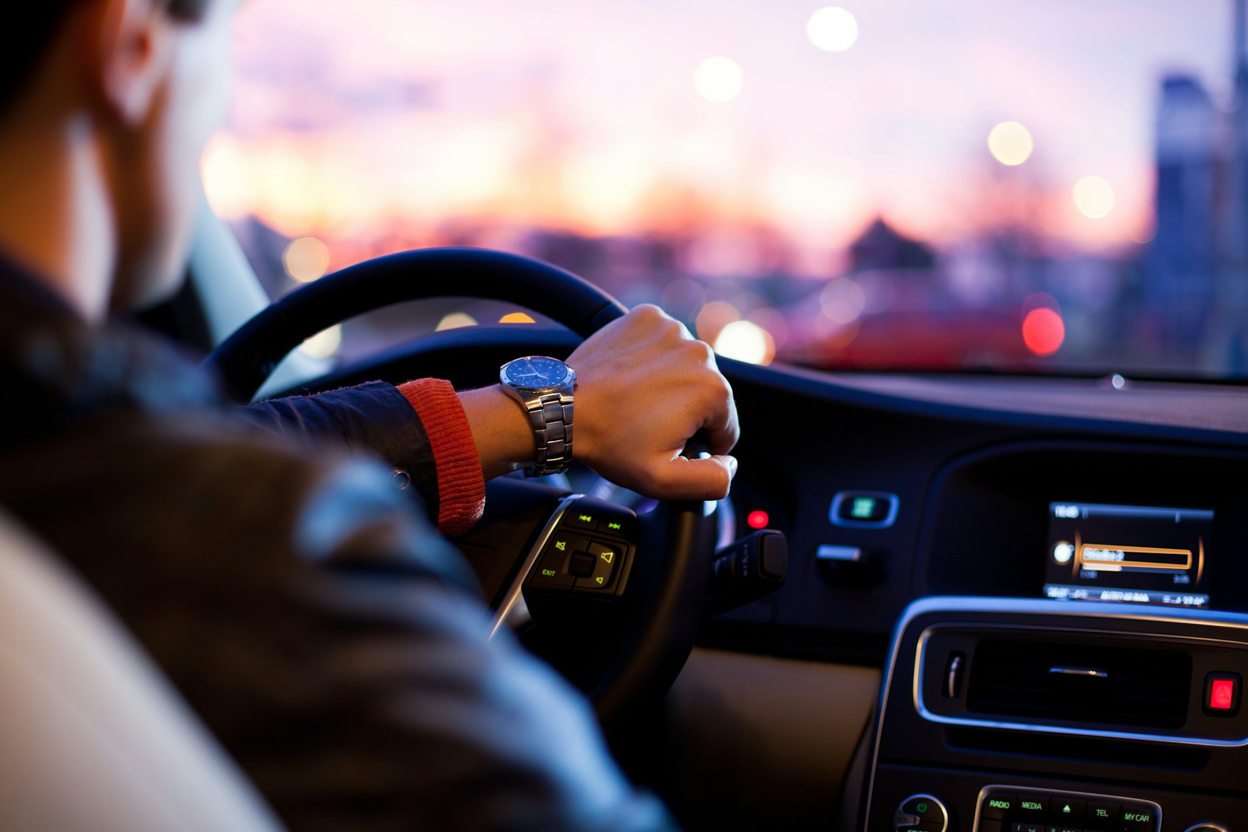 A driver at the wheel at dusk